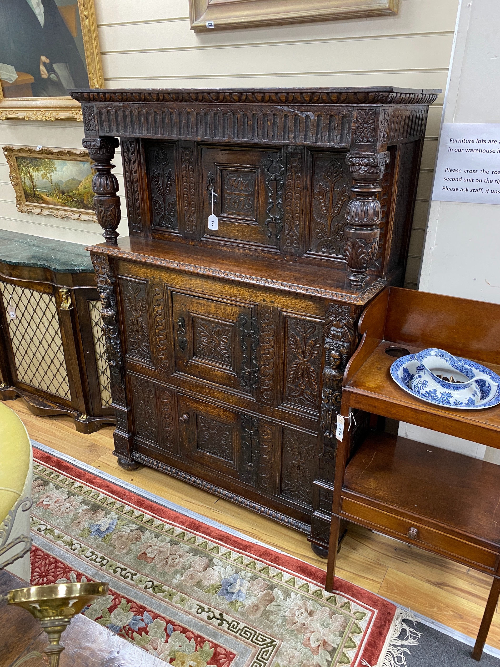 A 17th century carved oak press cupboard, width 112cm, depth 51cm, height 159cm